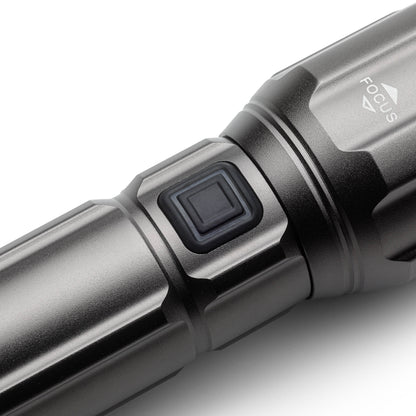 Power button on the side of handheld flashlight