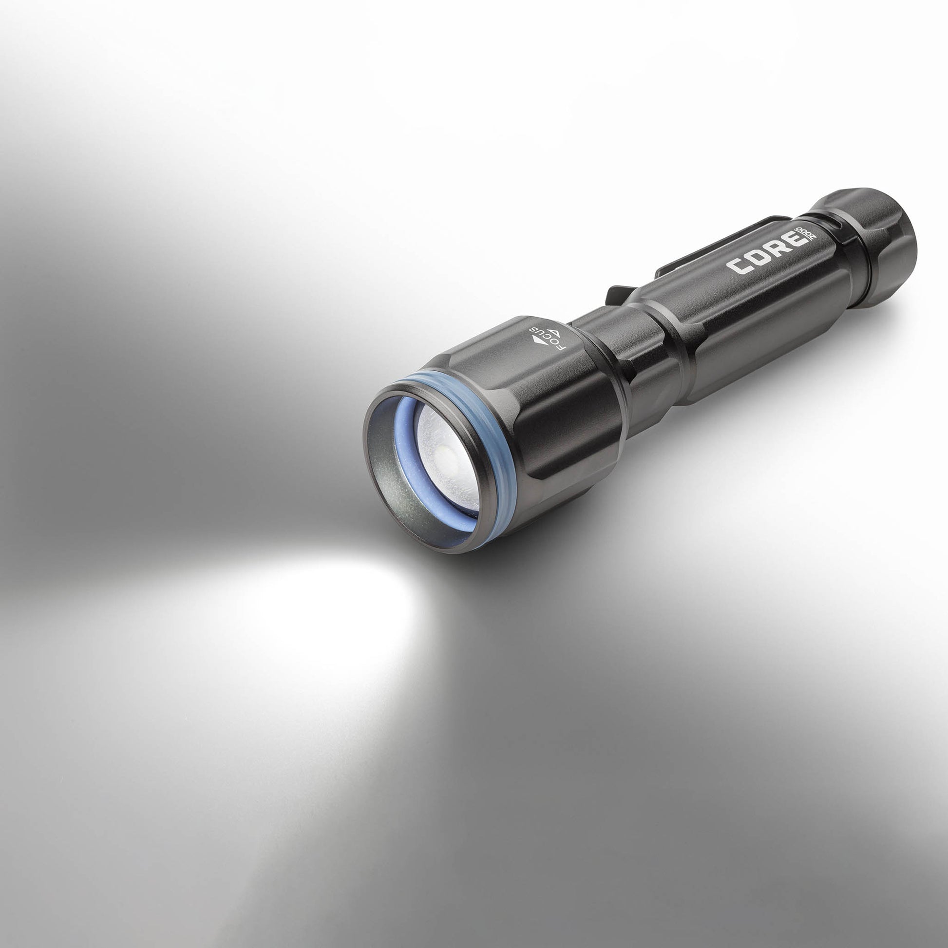 Dark gray CORE 2000 lumen rechargeable flashlights with blue accents, turned on. 